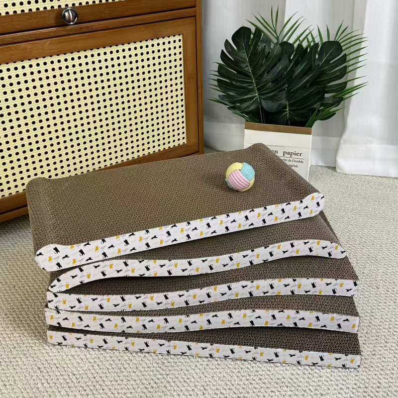Curved corrugated cardboard cat scratching boards with a toy ball